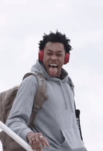 Man Wearing Headphones And Backpack Sticking Tongue Out GIF