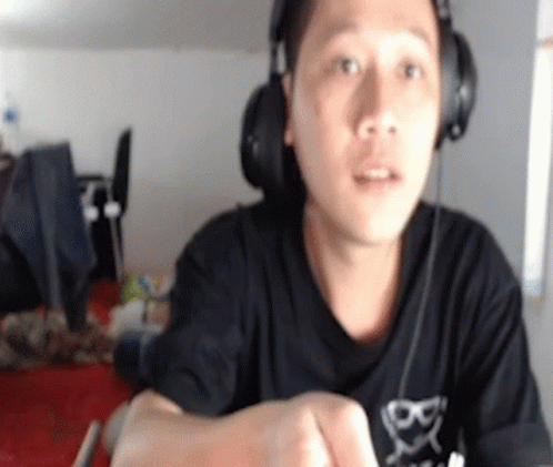 Man Wearing Headphones and Cross Shirt