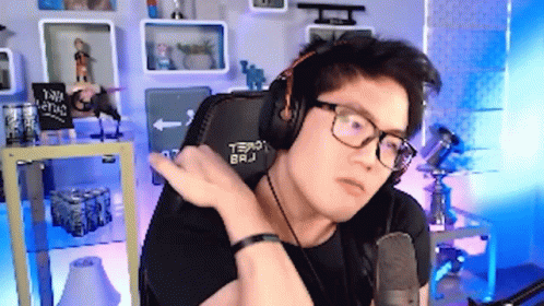 Man Wearing Headphones and Glasses at Microphone