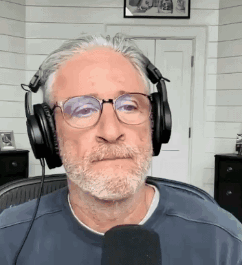 Man Wearing Headphones And Glasses At Microphone GIF