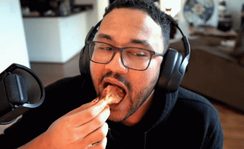 Man Wearing Headphones And Glasses Eating GIF