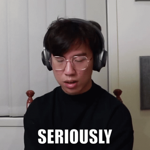 Man Wearing Headphones And Glasses With Seriously On Face