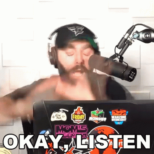 Man Wearing Headphones and Hat Behind Microphone Says Okay Listen