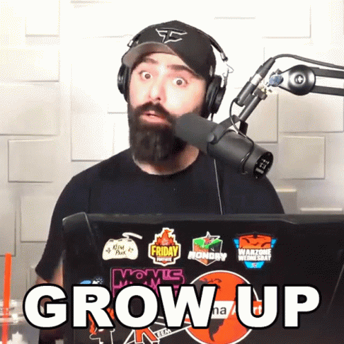 Man Wearing Headphones and Hat in Front of Microphone Saying Grow Up