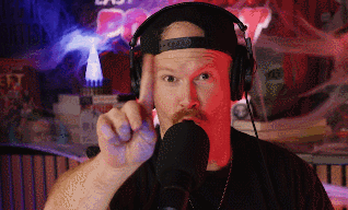Man Wearing Headphones and Hat Pointing