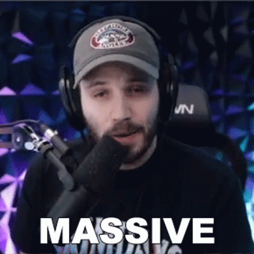 Man Wearing Headphones And Hat Saying Massive GIF