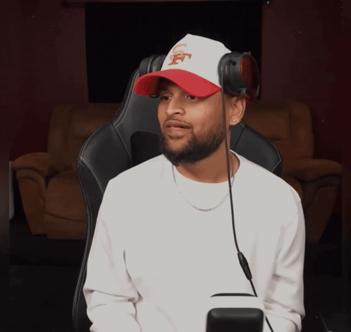 Man Wearing Headphones and Jets Hat