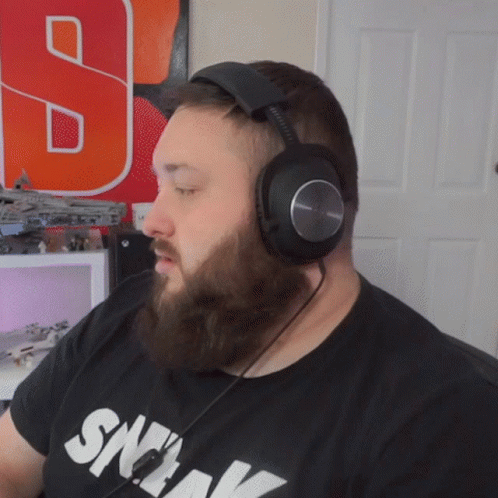 Man Wearing Headphones and Sneak Shirt