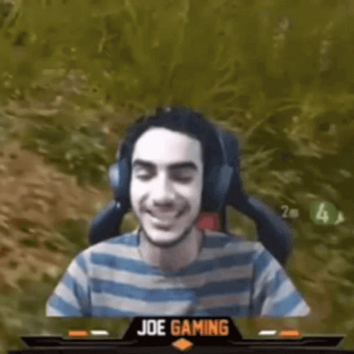Man Wearing Headphones and Striped Shirt Sitting in Chair
