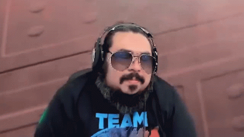 Man Wearing Headphones and Sunglasses with Team Shirt