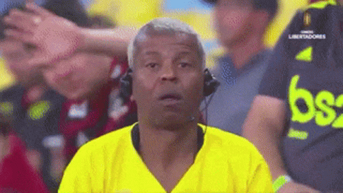 Man Wearing Headphones And Yellow Shirt With Letter B GIF