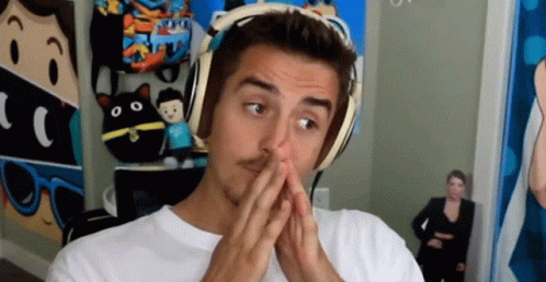 Man Wearing Headphones Covering Mouth With Hands GIF
