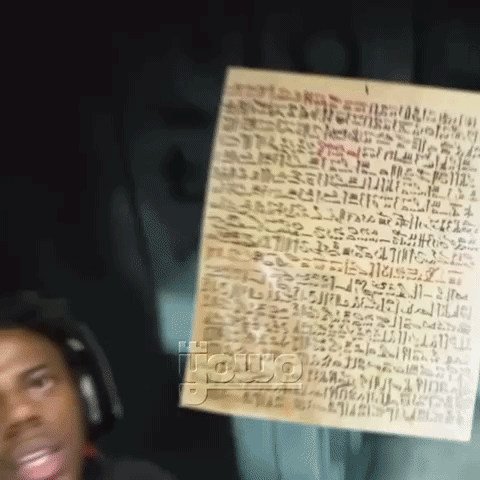 Man Wearing Headphones Holding Paper With Writing GIF