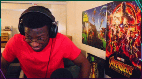 Man Wearing Headphones in Front of Avengers Infinity War Poster