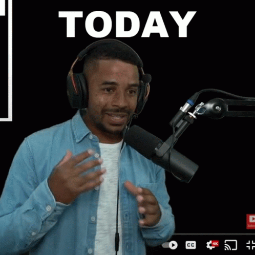 Man Wearing Headphones in Front of Microphone
