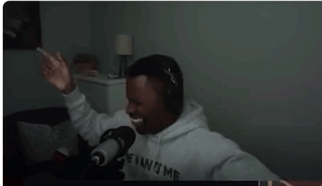 Man Wearing Headphones in Front of Microphone