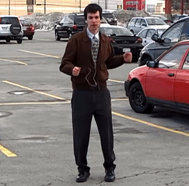 Man Wearing Headphones in Parking Lot