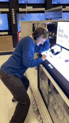 Man Wearing Headphones Looking at Beats Studio Pro