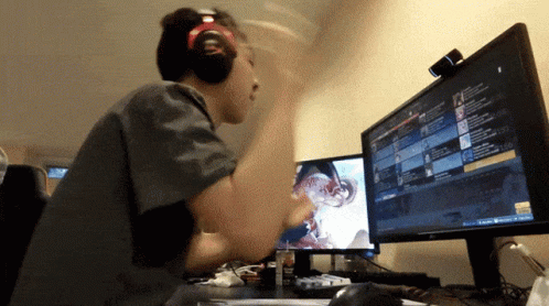 Man Wearing Headphones Playing Game on Computer