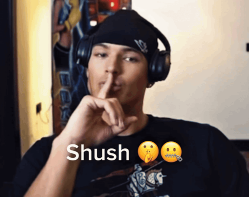 Man Wearing Headphones Saying Shush