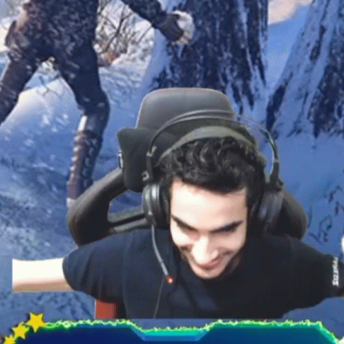 Man Wearing Headphones Sits in Chair
