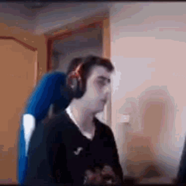Man Wearing Headphones Sitting at Computer