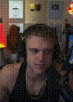 Man Wearing Headphones Sitting at Microphone