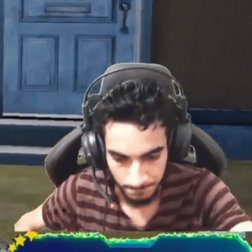 Man Wearing Headphones Sitting in Front of Computer Screen