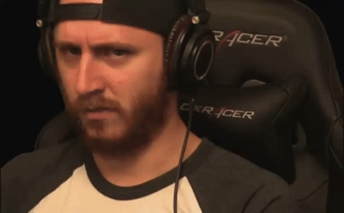 Man Wearing Headphones Sitting in Gaming Chair