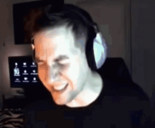 Man Wearing Headphones Smiling at Computer