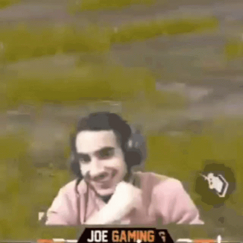Man Wearing Headphones Smiling While Playing Video Game