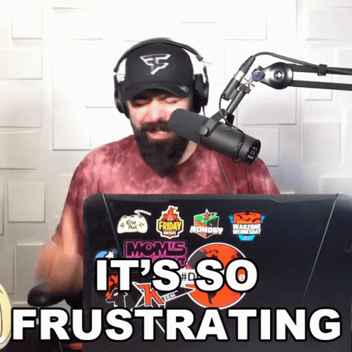 Man Wearing Headphones Stands in Front of Microphone Saying It's So Frustrating