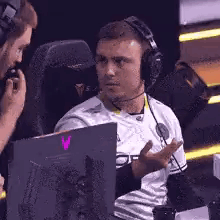 Man Wearing Headphones Talking to Another