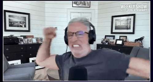 Man Wearing Headphones Weekly Show With Jon Stewart GIF