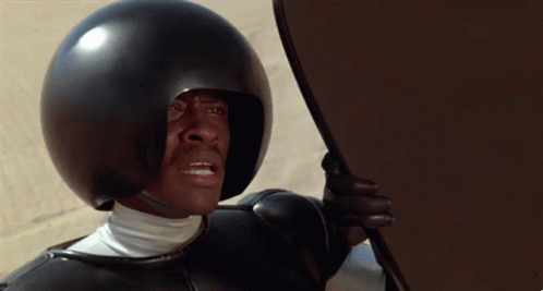 Man Wearing Helmet Holding Shield We