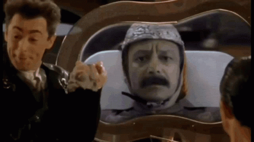 Man Wearing Helmet Looking at Another