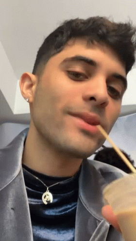 Man Wearing Horseshoe Necklace Eating with Chopsticks