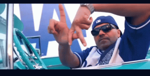 Man Wearing M Hat Giving Middle Finger