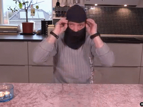 Man Wearing Mask Next to Candle