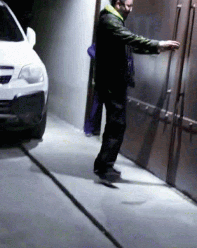 Man Wearing Mask Next to Car