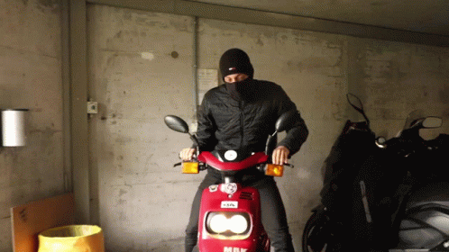 Man Wearing Mask Riding Red Scooter
