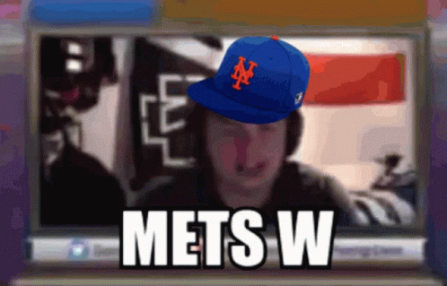 Man Wearing Mets Hat on Computer