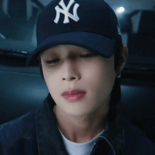 Man Wearing New York Yankees Hat Looking Down