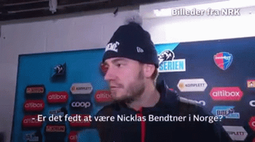 Man Wearing Nike Beanie In Front Of Bildeder Fra Nrk Sign GIF