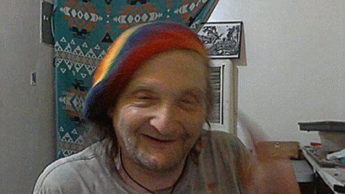 Man Wearing Rainbow Hat Smiling