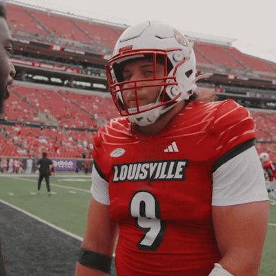 Man Wearing Red Louisville Jersey Number 9