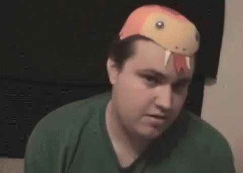 Man Wearing Snake Hat Making Funny Face