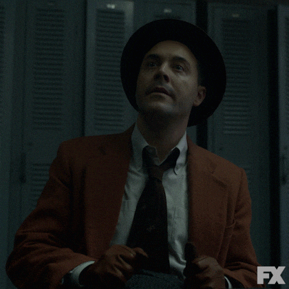 Man Wearing Suit Ear Plugs GIF