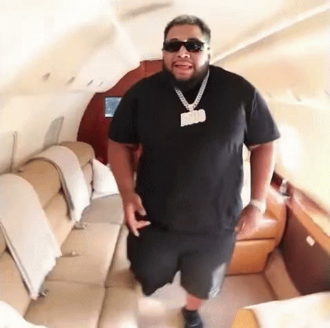 Man Wearing Sunglasses And Daddy Necklace In Jet GIF