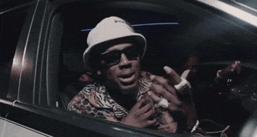 Man Wearing Sunglasses and Hat in Car